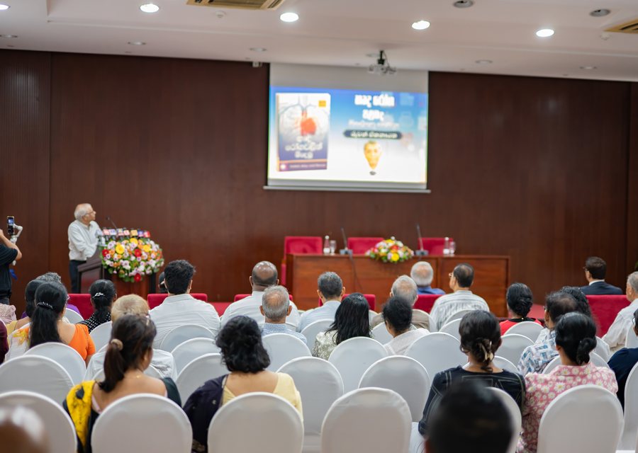 The audience at the book launch in Colombo, with the presentation screen behind the podium