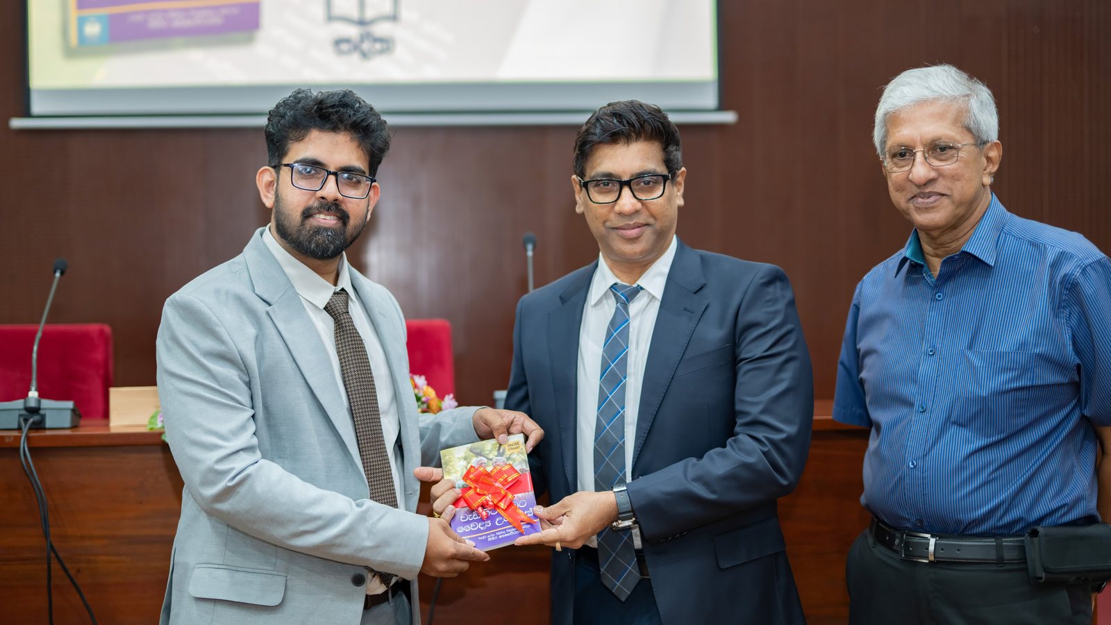 Dr Sithira Senevirathne presenting his book at the launch in Colombo, with two guests