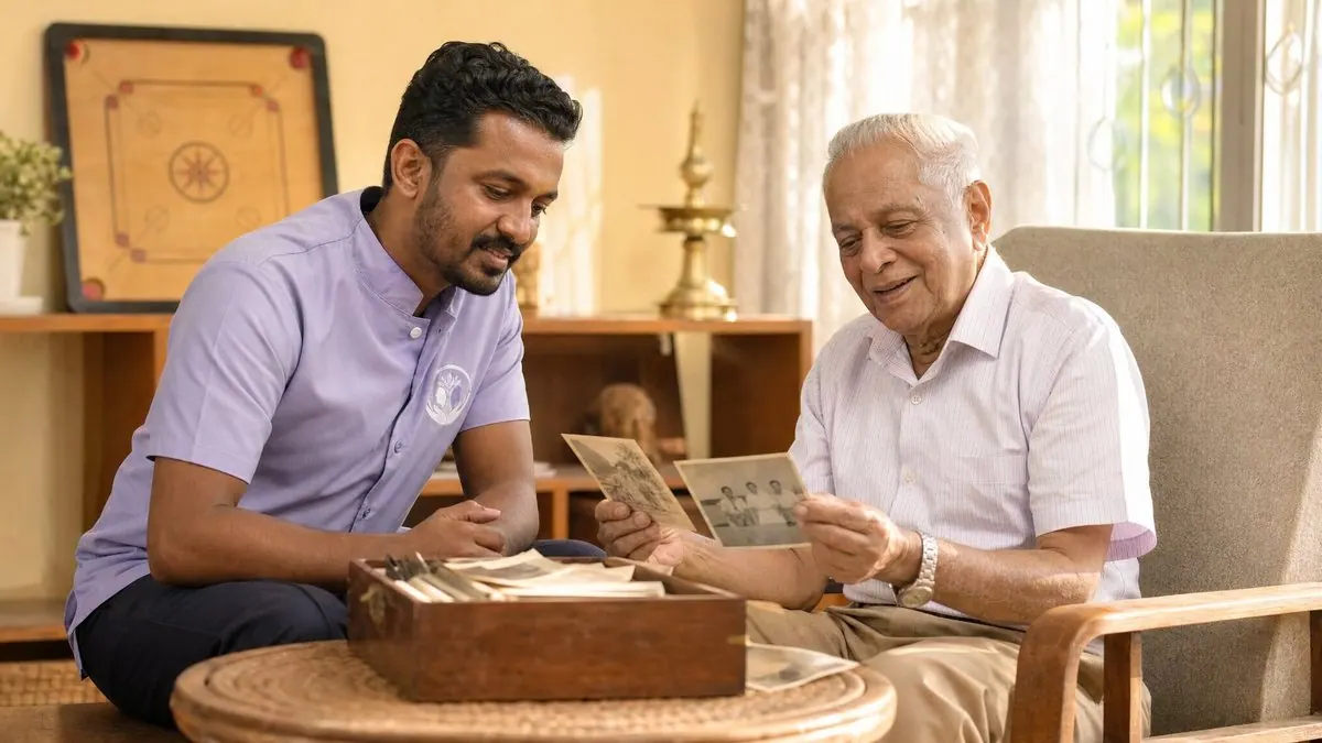 An Aegis Health carer in the lavender Aegis uniform looking through a box of family photographs with an older Sri Lankan man during a reminiscence session